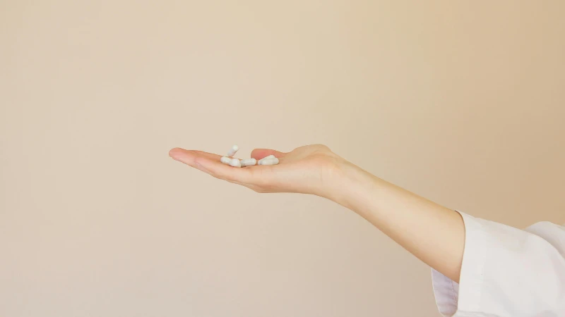 hand holding pills Woman's hand holding multivitamins